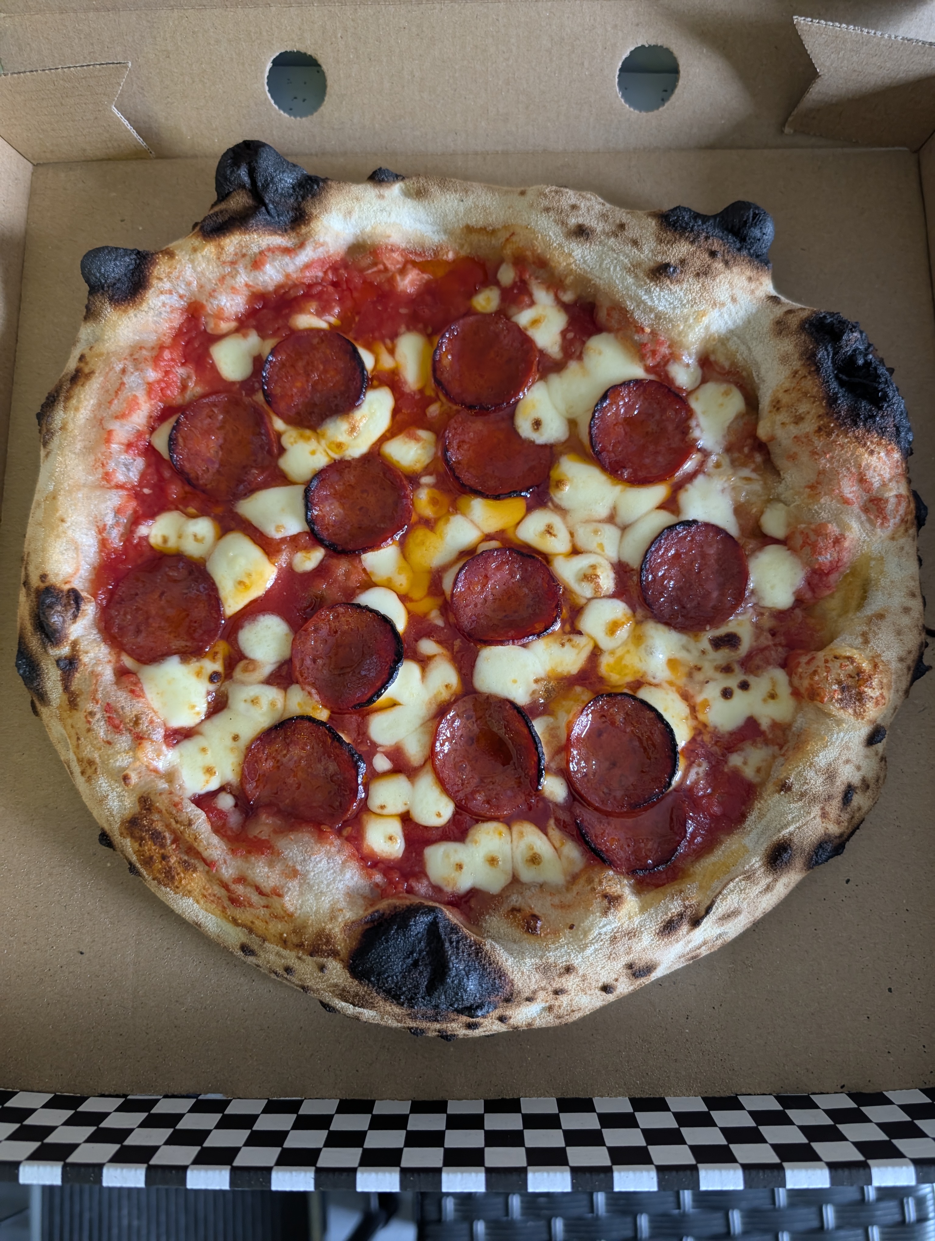 Pepperoni pizza cooked in mobile pizza trailer